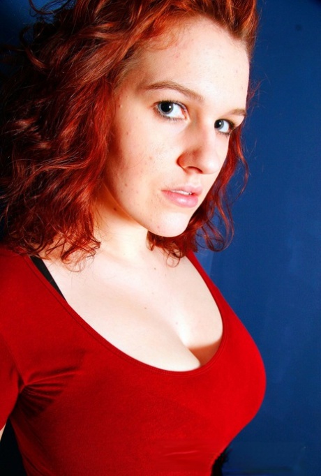 Chubby redhead Eva sets her big natural tits free of a brassiere 38089637