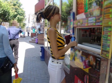 Nice young girl picks up a bottle of soda while wearing a miniskirt in public 47663598