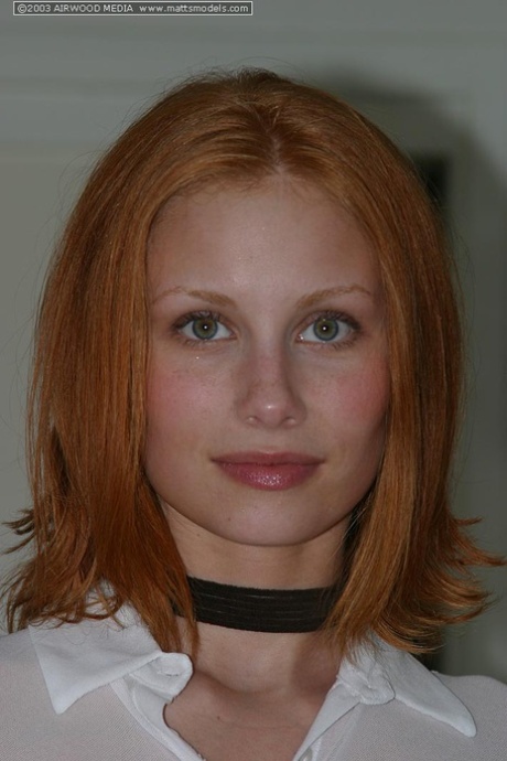 Pale redhead Anya poses naked on kitchen counter in a black choker 77970895