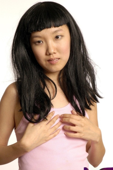 Young Asian amateur Youmi gets naked on a bed in a playful manner 76647426
